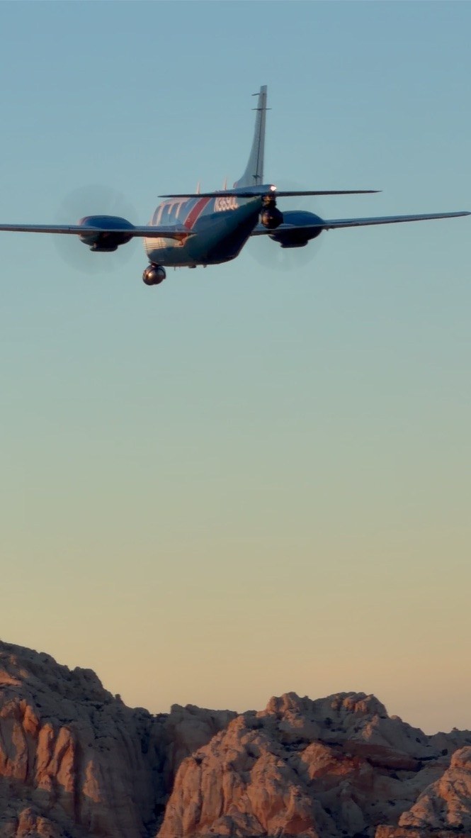 The Aerostar in flight over red rock country at golden hour