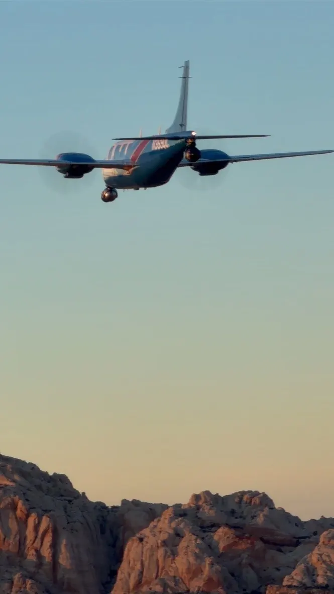 The Aerostar in flight over red rock country at golden hour