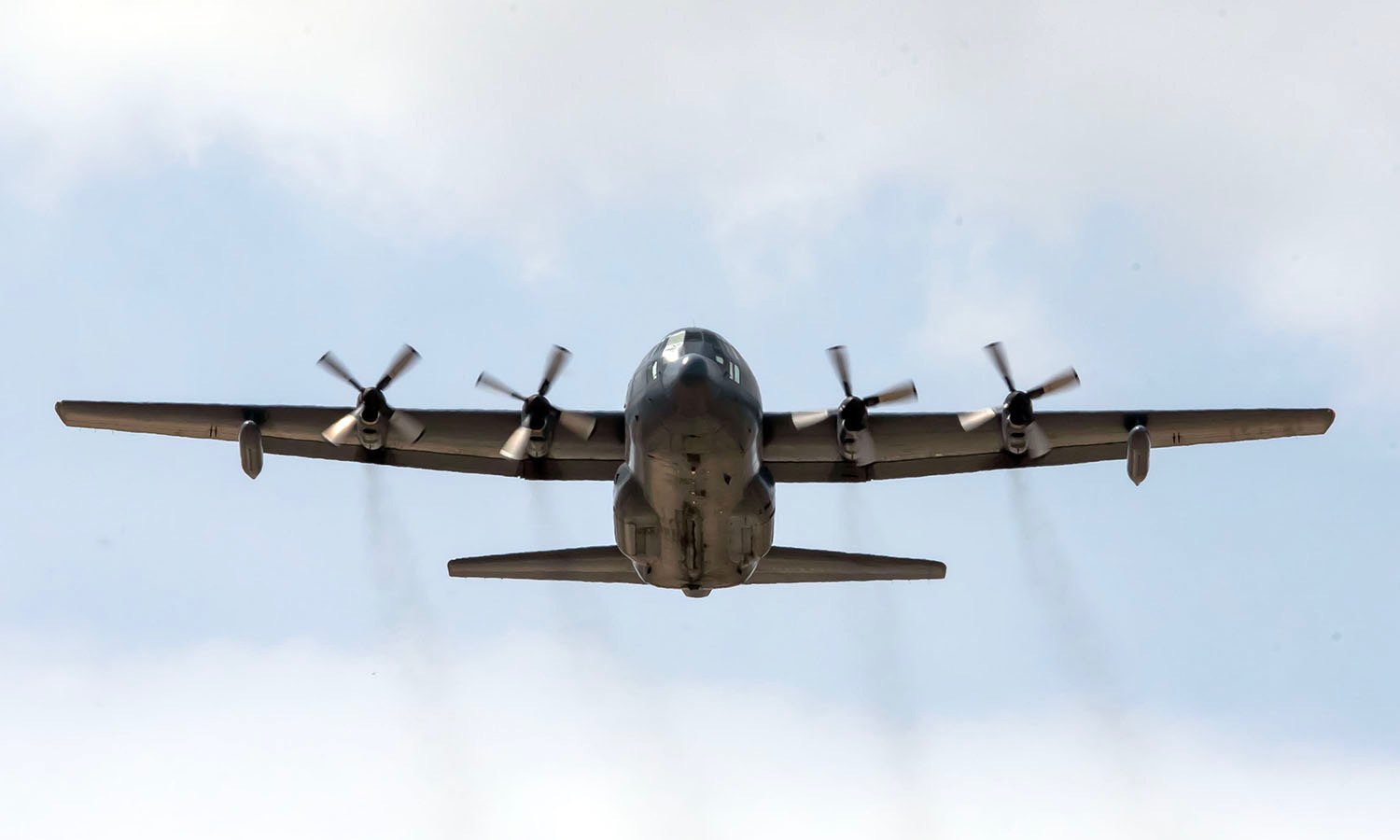 C-130 Hercules head-on in flight, four propellers turning