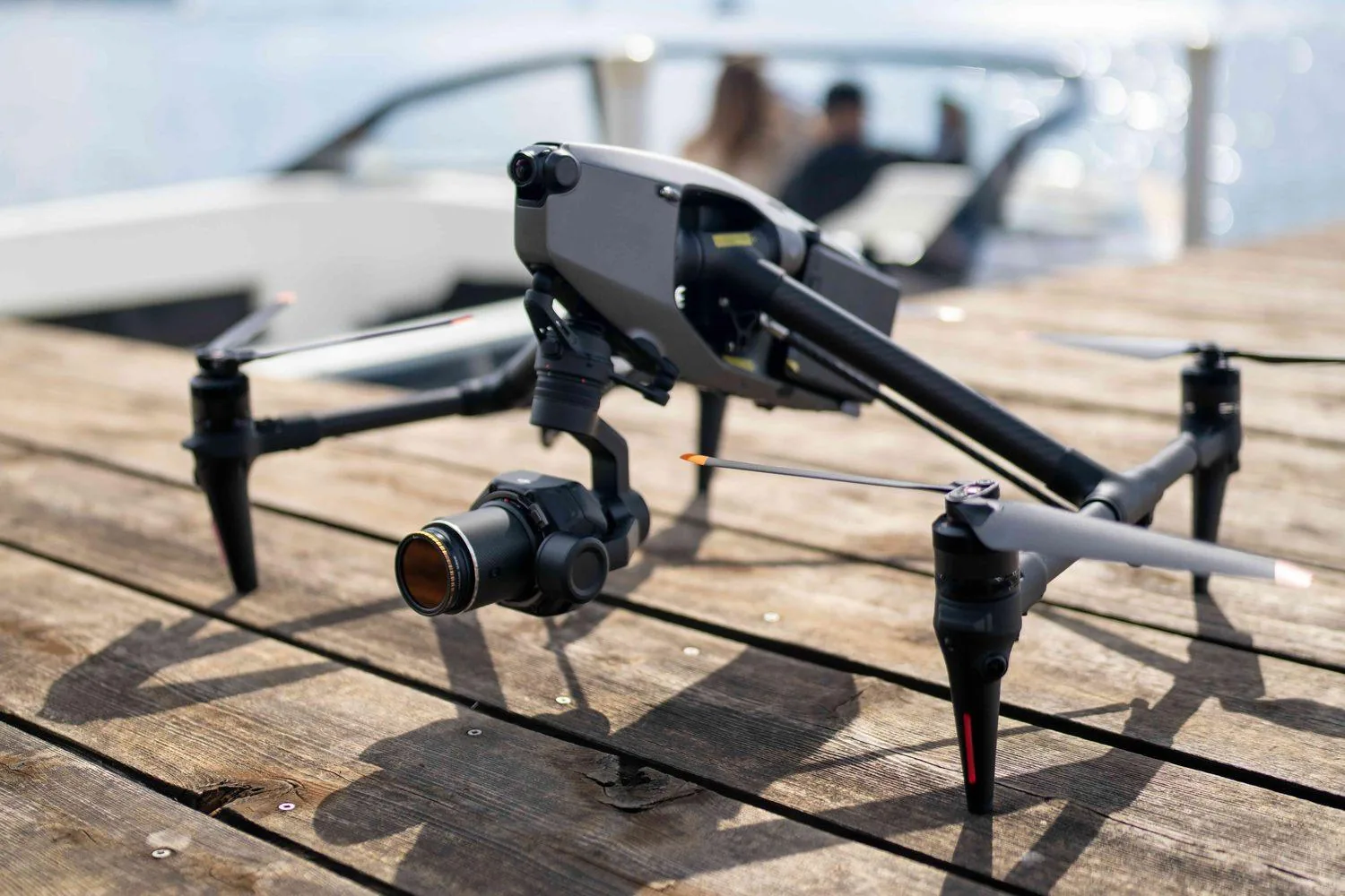 XBRAND's DJI Inspire 3 on a wooden dock with a boat behind it