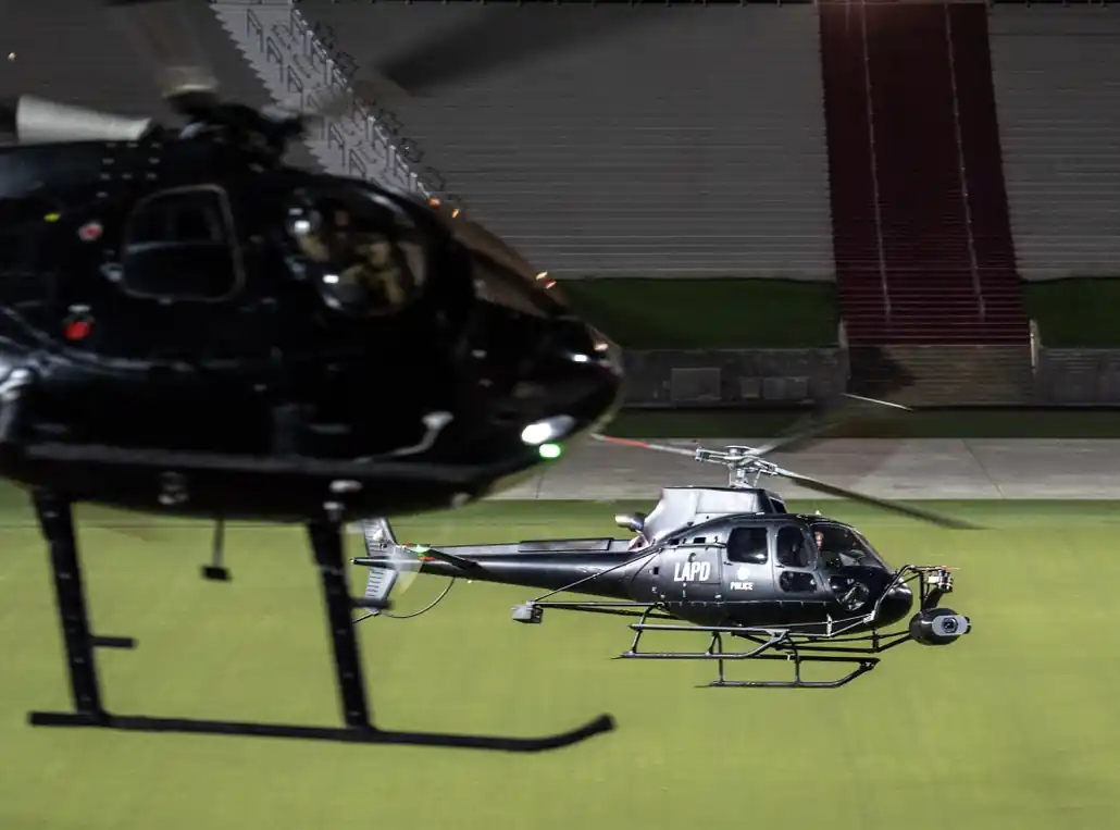 Camera helicopter flying low inside a stadium