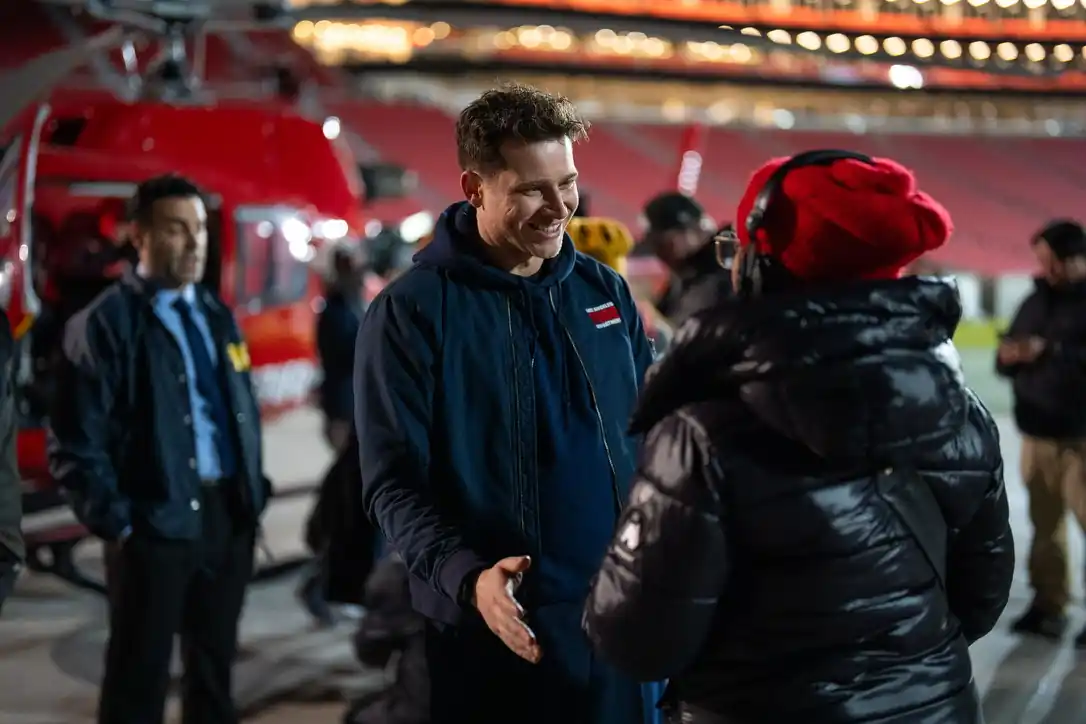Cast and crew talking on set at night