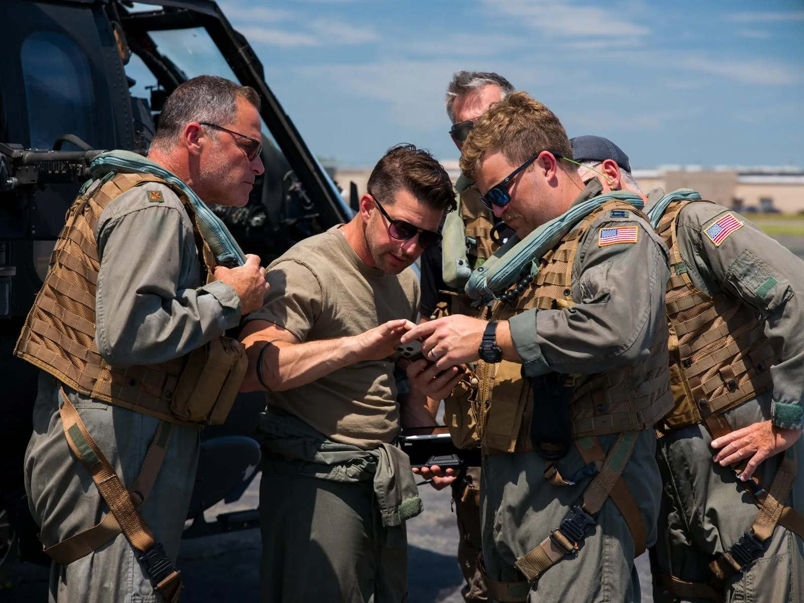 Kevin LaRosa II with aircrew in flight gear beside a helicopter