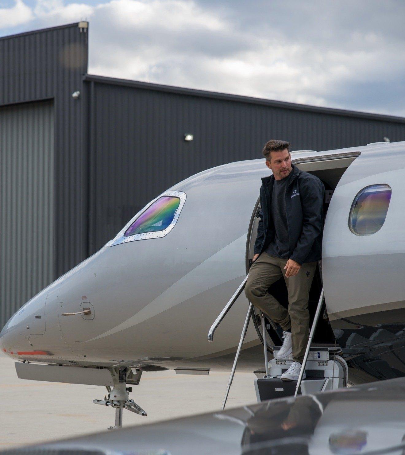 Kevin LaRosa II stepping out of a jet door on the ramp