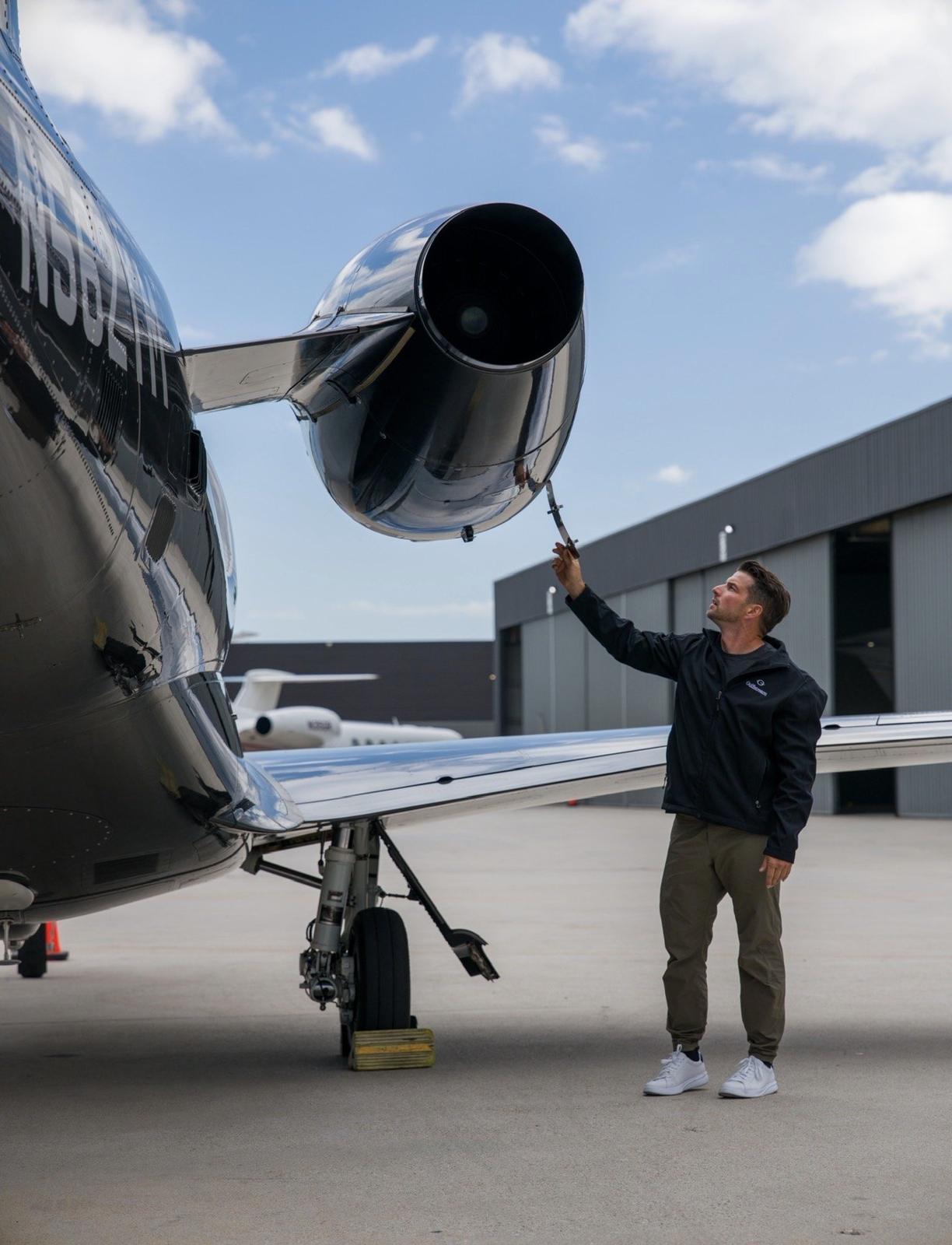 Kevin LaRosa II inspecting a jet engine on the ramp