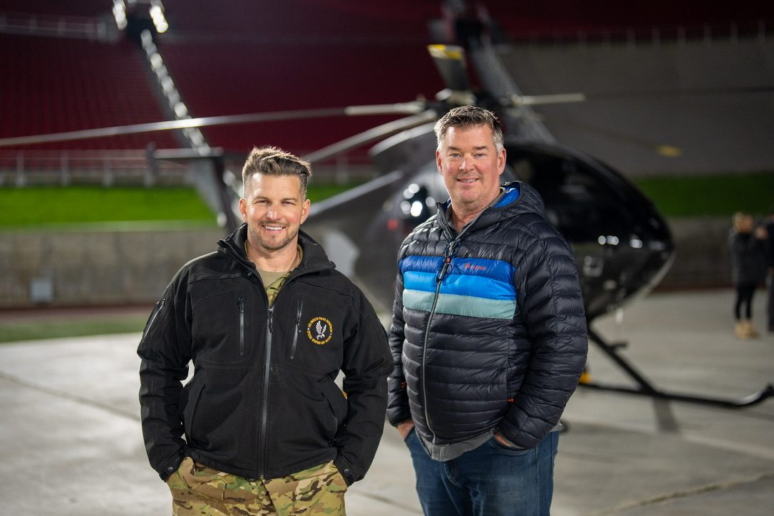 Two men on the ramp beside a helicopter