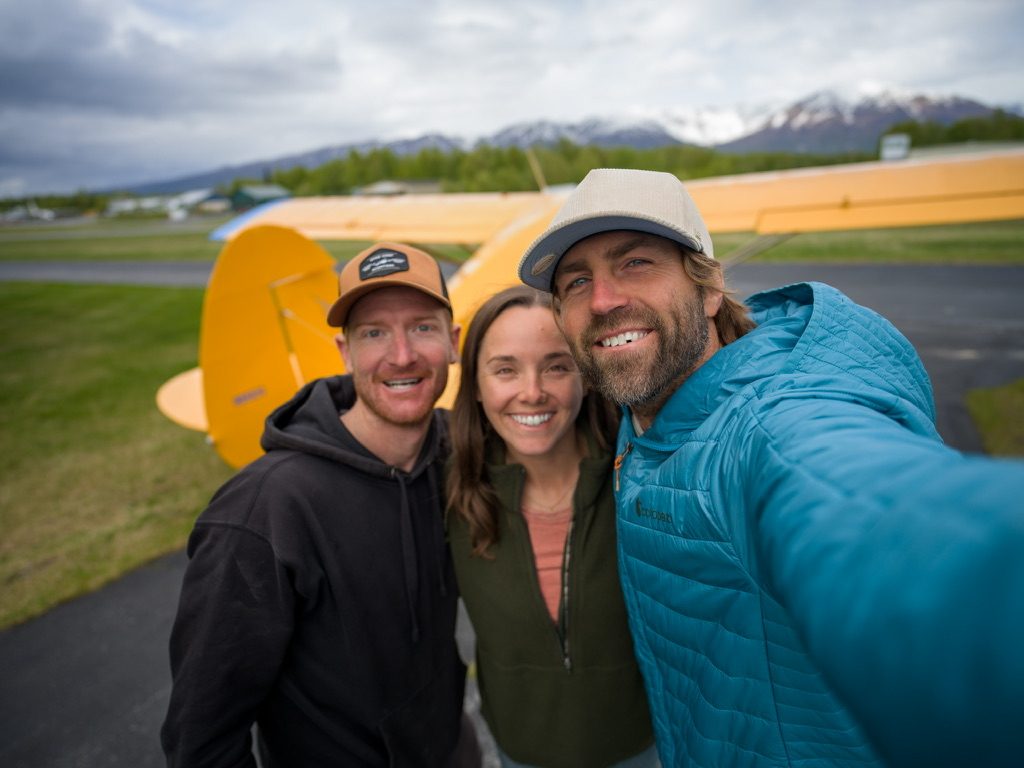 Jordan Orsak smiling with friends on a mountain airfield