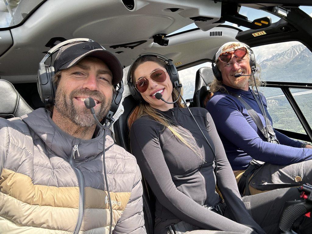 Jordan Orsak in a helicopter with headsets on