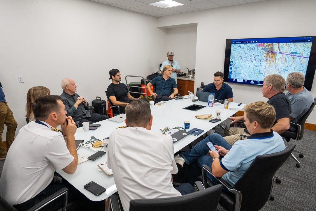 A production briefing around a conference table